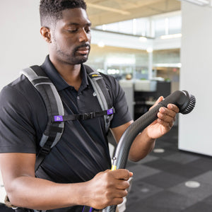 Operator holding a GoHigh 135-degree bend with round dust brush in an office