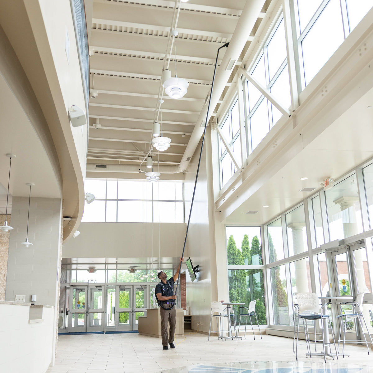 Cleaning a high HVAC duct from the floor with GoHigh Max in an atrium